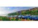 Stunning waterfront view of multi-story condominiums, boat docks, and vibrant red flowers at 2757 Via Cipriani # 1114A, Clearwater, FL 33764