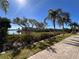 Scenic waterfront view with palm trees, hedges and waterfront dock at 2757 Via Cipriani # 1114A, Clearwater, FL 33764