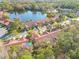 Aerial view of neighborhood showcasing lush landscaping, pond and community layout at 3985 Mermoor Dr, Palm Harbor, FL 34685