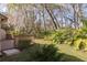 A backyard with a wooden deck, lush foliage and lots of large trees at 3985 Mermoor Dr, Palm Harbor, FL 34685