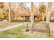 Single story home situated among mature landscaping and manicured lawn at 3985 Mermoor Dr, Palm Harbor, FL 34685