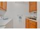 Laundry room featuring a sink with wood cabinets, and folding rack at 3985 Mermoor Dr, Palm Harbor, FL 34685