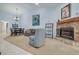 Cozy living room with a fireplace, dining area, and comfortable seating at 3985 Mermoor Dr, Palm Harbor, FL 34685