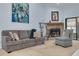 A living room with a comfortable gray sofa, stone fireplace, and sliding glass doors leading to the outside at 3985 Mermoor Dr, Palm Harbor, FL 34685