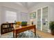 Bright office area featuring hard wood desk, shelves filled with books and sunny light at 3985 Mermoor Dr, Palm Harbor, FL 34685