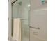 Bathroom shower with clear glass doors, showerhead and towel rack at 3985 Mermoor Dr, Palm Harbor, FL 34685