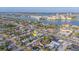 Up close, aerial view of neighborhood with city skyline and the location of the property marked with yellow arrow at 421 77Th Ave, St Pete Beach, FL 33706