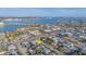 An aerial view of the property in a mixed commercial and residential neighborhood is marked by a yellow arrow at 421 77Th Ave, St Pete Beach, FL 33706