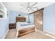 Bright bedroom featuring wood-look flooring, ceiling fan, and decorative barn door, creating a cozy retreat at 421 77Th Ave, St Pete Beach, FL 33706