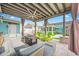 Covered outdoor space featuring comfortable seating around a fire pit table and a ceiling fan at 421 77Th Ave, St Pete Beach, FL 33706