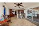 Bright living room flowing into kitchen with counter seating and sliding glass doors to outdoor space at 9372 121St St, Seminole, FL 33772