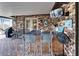 Covered brick bar area with television, seating, and outdoor access at 10020 Kenda Dr, Riverview, FL 33578