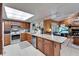 Bright kitchen featuring granite countertops, stainless appliances, and breakfast bar at 10020 Kenda Dr, Riverview, FL 33578