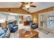 Cozy living room with wood paneling, ceiling fan, and open concept design at 10020 Kenda Dr, Riverview, FL 33578