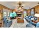 Comfortable living room with fireplace, wood paneling, and outdoor access at 10020 Kenda Dr, Riverview, FL 33578