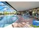 Relaxing screened-in pool area with brick patio and outdoor dining space at 10020 Kenda Dr, Riverview, FL 33578