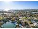 A high aerial view highlights the property in a waterfront neighborhood with ocean views and boating access at 10128 Paradise Blvd, Treasure Island, FL 33706