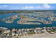 Wide aerial shot showcasing waterfront real estate in Treasure Island, Florida, offering stunning bay views at 10128 Paradise Blvd, Treasure Island, FL 33706
