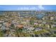 An aerial view displays the beautiful waterfront neighborhood, coastal views and its desirable location at 10128 Paradise Blvd, Treasure Island, FL 33706