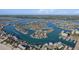 Stunning aerial view of the waterfront community with numerous canals and gorgeous bay views at 10128 Paradise Blvd, Treasure Island, FL 33706