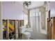 Bathroom with missing walls, featuring a toilet and tub with curtain at 10128 Paradise Blvd, Treasure Island, FL 33706