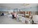 Living area needing sheetrock repair, ready for renovation with an open layout and natural light at 10128 Paradise Blvd, Treasure Island, FL 33706