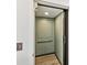 A convenient elevator with green wallpaper and an assist bar for accessibility at 1055 Philippe Pkwy, Safety Harbor, FL 34695