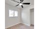 Bright bedroom with light wood floors, ceiling fan, and a window view at 11712 128Th Ave, Largo, FL 33778