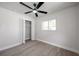 This bedroom has modern wood-look floors, closet, large window and a ceiling fan at 11712 128Th Ave, Largo, FL 33778