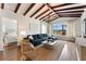 Living room featuring wood beams, hardwood floors, and modern furnishings at 15804 Redington Dr, Redington Beach, FL 33708