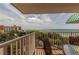 Balcony with chairs and table, featuring views of the ocean and trees at 18400 Gulf Blvd # 1505, Indian Shores, FL 33785