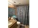 Cozy bathroom with granite countertops, decorative shower curtain, and soft towels adding warmth and character at 18400 Gulf Blvd # 1505, Indian Shores, FL 33785