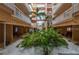 Beautiful condo courtyard featuring palm trees, tropical plants, and a fountain at 18400 Gulf Blvd # 1505, Indian Shores, FL 33785