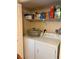 Laundry room with full-sized washer and dryer plus storage shelves at 18400 Gulf Blvd # 1505, Indian Shores, FL 33785