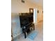 Living room featuring a modern television setup, tile floors, and ample storage with access to other rooms at 18400 Gulf Blvd # 1505, Indian Shores, FL 33785