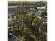 Lush palm trees offer partial coverage of a business and parking in a residential area at 18400 Gulf Blvd # 1505, Indian Shores, FL 33785