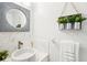 Stylish powder room with marble sink, decorative mirror, and greenery for a fresh touch at 2794 Countryside Blvd # 1, Clearwater, FL 33761