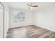 Bedroom featuring hardwood floors, a ceiling fan, and natural light at 2794 Countryside Blvd # 1, Clearwater, FL 33761