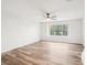 Bright bedroom with wood-look floors and large window at 2794 Countryside Blvd # 1, Clearwater, FL 33761