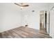Bedroom with wood-look floors, ceiling fan, and access to bathroom at 2794 Countryside Blvd # 1, Clearwater, FL 33761