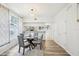 Bright dining room featuring hardwood floors, modern table and chairs, stylish light fixture, and large window at 2794 Countryside Blvd # 1, Clearwater, FL 33761