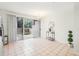 Bright dining room with tile flooring, a modern chandelier, and sliding glass doors to an enclosed patio at 2794 Countryside Blvd # 1, Clearwater, FL 33761