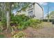 A beautiful view of the exterior of the home, lush landscape, and screened-in porch in a suburban setting at 2794 Countryside Blvd # 1, Clearwater, FL 33761
