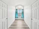 Hallway with wood-look floors, window, and doors at 2794 Countryside Blvd # 1, Clearwater, FL 33761