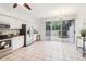 Spacious kitchen with stainless steel appliances, white cabinetry, granite countertops, and sliding door access to the patio at 2794 Countryside Blvd # 1, Clearwater, FL 33761