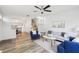 Open concept living room with hardwood floors, fireplace, modern furniture, staircase, and seamless transition to the dining area at 2794 Countryside Blvd # 1, Clearwater, FL 33761