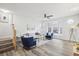Bright living room featuring wood floors, a ceiling fan, neutral paint, and a cozy seating area with a bay window at 2794 Countryside Blvd # 1, Clearwater, FL 33761