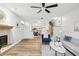 Stylish living room featuring hardwood floors, fireplace, modern furniture, open floorplan, and ample natural light at 2794 Countryside Blvd # 1, Clearwater, FL 33761