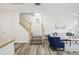 Bright living room featuring hardwood flooring, staircase, modern furniture, and neutral paint, creating a welcoming atmosphere at 2794 Countryside Blvd # 1, Clearwater, FL 33761