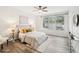 Bright bedroom with wood floors, a ceiling fan, neutral paint, and coordinated decor featuring a gray bed at 2794 Countryside Blvd # 1, Clearwater, FL 33761